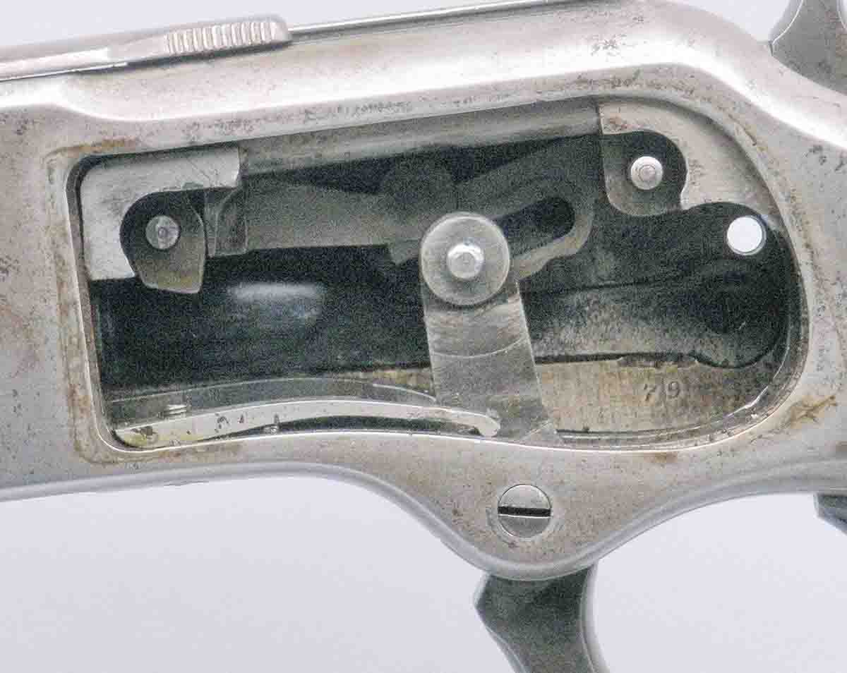 Toggle-link action shows the firing pin retractor on the left side, under the front link.